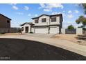 Two-story home with a three-car garage and well-maintained landscaping under blue sky at 5402 S 54Th Ln, Laveen, AZ 85339