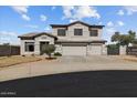 Charming two-story house features a three-car garage and landscaped front yard at 5402 S 54Th Ln, Laveen, AZ 85339