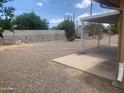 Spacious backyard featuring low maintenance landscaping and a covered patio area at 5702 E Casper Rd, Mesa, AZ 85205