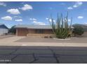 Single story home with desert landscaping featuring a large cactus in the front yard at 5702 E Casper Rd, Mesa, AZ 85205