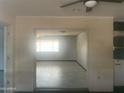 Neutral-toned living room features an open layout and ample natural light from the large window at 5702 E Casper Rd, Mesa, AZ 85205