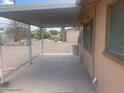 Covered patio providing a shaded outdoor space with low maintenance landscaping and privacy fencing at 5702 E Casper Rd, Mesa, AZ 85205