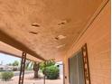 View of the porch showing damage to the porch ceiling that needs repair at 5702 E Casper Rd, Mesa, AZ 85205