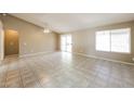 Bright and airy living room featuring tile flooring, sliding glass doors, and a ceiling fan at 6126 W Paradise Ln, Glendale, AZ 85306