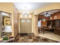 Grand foyer with tile floors, decorative columns, designer accents, and a charming chandelier at 6334 E Albany St, Mesa, AZ 85205