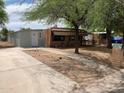 A charming home with a driveway and walkway, surrounded by natural landscaping and trees at 660 S 93Rd St, Mesa, AZ 85208