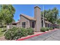 Beautiful home featuring a unique chimney design and mature flowering bushes at 7040 W Olive Ave # 94, Peoria, AZ 85345