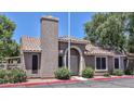 Inviting home featuring a secure screen door and mature trees at 7040 W Olive Ave # 94, Peoria, AZ 85345