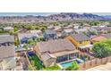Aerial view of a single-Gathering home featuring a swimming pool and mountain views in the background at 710 W Ardmore Rd, Phoenix, AZ 85041