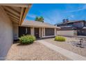 A warm entrance to this home features welcoming landscaping and a charming front door with a 'Welcome' sign at 7940 W Willow Ave, Peoria, AZ 85381