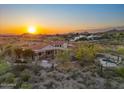 Aerial view of the house at sunset highlighting its pool and desert landscaping at 8540 E Mcdowell Rd # 119, Mesa, AZ 85207