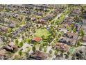 An aerial view of a neighborhood with a park, showcasing mature trees and well-maintained homes at 953 W Ridge Rd, Apache Junction, AZ 85120