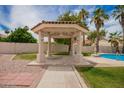 Picturesque gazebo near a refreshing pool, set in a beautifully landscaped backyard at 10130 E San Salvador Dr, Scottsdale, AZ 85258
