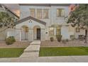 Inviting two-story home featuring a stucco facade, manicured landscaping and covered front porch entry at 10428 E Nopal Ave, Mesa, AZ 85209