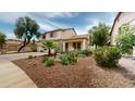 Charming two-story home featuring lush desert landscaping and a welcoming front porch at 10441 W Windsor Ave, Avondale, AZ 85392