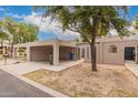 Beige home exterior with carports shaded by mature trees at 1173 E Cochise Dr, Phoenix, AZ 85020