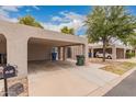 Beige home exterior with a carport and a charming desert landscape at 1173 E Cochise Dr, Phoenix, AZ 85020