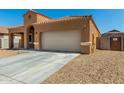 Stylish single-story home showcasing desert landscaping, a tile roof, and an attached two-car garage at 1223 E Palo Verde Dr, Casa Grande, AZ 85122