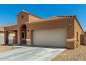 Attractive single-story home boasting a tile roof, desert landscaping, and attached two-car garage at 1223 E Palo Verde Dr, Casa Grande, AZ 85122