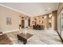 Bright, open-concept living and dining room with modern wood-look tile flooring at 12448 N 129Th Pl, Scottsdale, AZ 85259