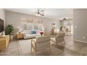 Bright living room with tile floors, natural light, ceiling fan, and neutral decor at 125 N 22Nd Pl # 53, Mesa, AZ 85213