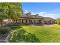 Charming home with large lawn, welcoming porch, and attached three-car garage at 1409 E Dove Pl, Casa Grande, AZ 85122
