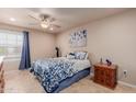 Comfortable bedroom with ceiling fan and decorative blue accents at 17205 N 107Th Ave, Sun City, AZ 85373