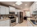 Bright kitchen with white cabinets, stainless steel appliances and a granite countertop at 17205 N 107Th Ave, Sun City, AZ 85373