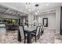 Open-concept dining room featuring pendant lighting, a coffered ceiling, and direct access to the living room at 1725 E Everglade Ln, Gilbert, AZ 85298