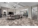 Spacious living room features a coffered ceiling, tile floors, and an open floor plan with seamless access to dining area at 1725 E Everglade Ln, Gilbert, AZ 85298