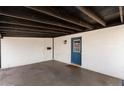 Covered carport featuring a painted door and white brick walls at 1939 E Alameda Dr, Tempe, AZ 85282