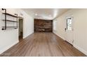 Open-concept living room with sleek flooring and a distinctive wood accent wall at 1939 E Alameda Dr, Tempe, AZ 85282