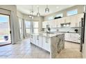 Beautiful kitchen with granite island, sleek white cabinets, and stainless steel appliances at 20906 N 56Th Dr, Glendale, AZ 85308