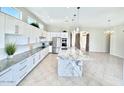 Bright, spacious kitchen with white cabinets, granite countertops, and stainless steel appliances at 20906 N 56Th Dr, Glendale, AZ 85308