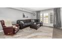 Comfortable living room with modern furniture and a door to an outdoor space at 2121 W Union Hills Dr # 113, Phoenix, AZ 85027
