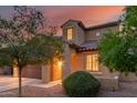 Two-story home featuring desert landscaping, a two car garage, and architectural details at 2324 W Melody Dr, Phoenix, AZ 85041