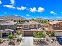 Expansive aerial view of a two-story home with mountain views and blue skies at 2387 E Runaway Bay Pl, Gilbert, AZ 85298