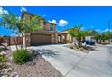 Well-maintained two-story home featuring a spacious driveway and mature landscaping at 2387 E Runaway Bay Pl, Gilbert, AZ 85298