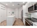Bright kitchen featuring white cabinetry, stainless appliances, and a kitchen island at 2511 W Queen Creek Rd # 174, Chandler, AZ 85248