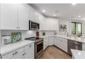 Modern kitchen featuring white cabinets, stainless steel appliances, and sleek countertops at 2511 W Queen Creek Rd # 174, Chandler, AZ 85248