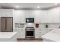Modern kitchen with white cabinets, stainless steel appliances, and stylish countertops at 2511 W Queen Creek Rd # 174, Chandler, AZ 85248