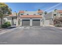 Charming townhome showcasing a red-tiled roof and a convenient two-car garage, enhancing curb appeal at 2524 S El Paradiso Dr # 82, Mesa, AZ 85202