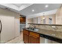 Kitchen with stainless steel dishwasher and view of laundry area at 3235 E Camelback Rd # 124, Phoenix, AZ 85018