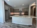 A well-equipped kitchen features a large island, granite countertops, and ample cabinet space at 3248 W San Cristobal Rd, San Tan Valley, AZ 85144