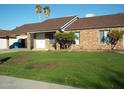 Charming single-story brick home featuring manicured lawn, attached garage and a welcoming front entrance at 3730 W North Ln, Phoenix, AZ 85051