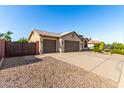Charming home with a three-car garage, tile roof, neutral colors, and minimal landscaping at 4214 W Marco Polo Rd, Glendale, AZ 85308