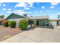 Inviting exterior view of a home with a covered driveway, charming landscaping, and a convenient storage shed at 4346 W Mescal St, Glendale, AZ 85304