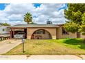 Charming single-story home with a covered carport and inviting curb appeal at 4438 W Hatcher Rd, Glendale, AZ 85302