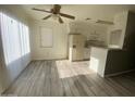 Bright kitchen features white cabinets, modern appliances, and luxury vinyl flooring, creating a welcoming culinary space at 4820 N 89Th Ave # 88, Phoenix, AZ 85037