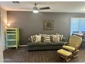 Comfortable living room featuring wood flooring, sofa with pillows, and an accent cabinet at 491 E Jeanne Ln, San Tan Valley, AZ 85140